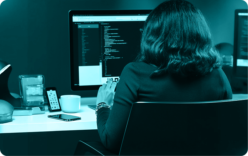 Analyst reviewing code while working toward CMMC and NIST 800-171 compliance