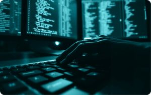 Analyst reviewing evidence on dark dual monitors while preparing for a DIBCAC High assessment